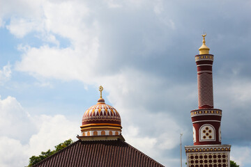 Beautifully designed mosque dome and minaret under a bright