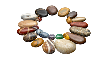 A circular arrangement of smooth, colorful stones against a black background. The stones vary in shape, size, and texture