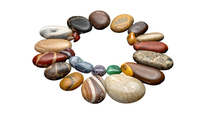 A circular arrangement of smooth, colorful stones against a black background. The stones vary in shape, size, and texture