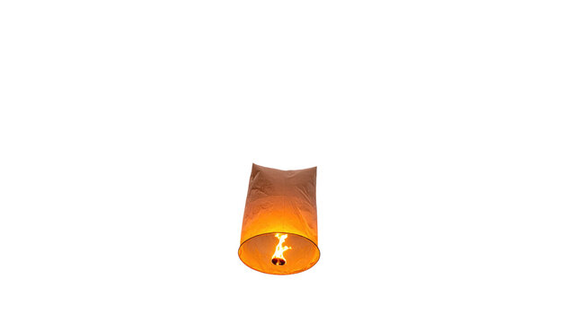 A single paper lantern illuminated from within floating against a stark, black background. The flame creates a warm glow