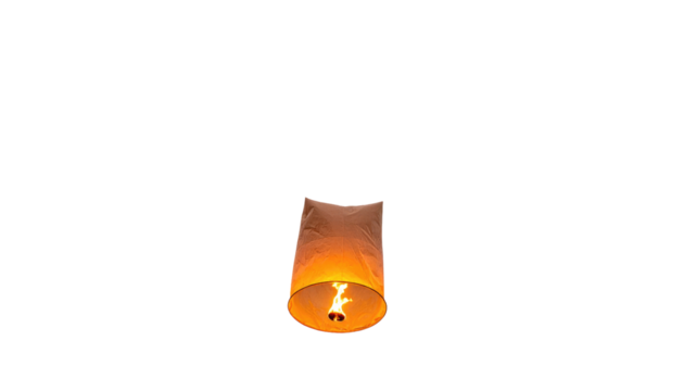 A single paper lantern illuminated from within floating against a stark, black background. The flame creates a warm glow