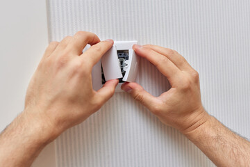 male hands of electrician installing electric light switch at home. Replacing.
