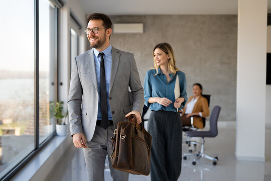 Professionals in a modern office environment discussing work-related matters