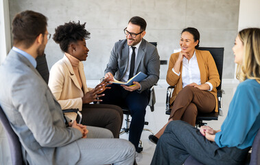 Business colleagues demonstrate teamwork, collaboration, communication, and strategy in office