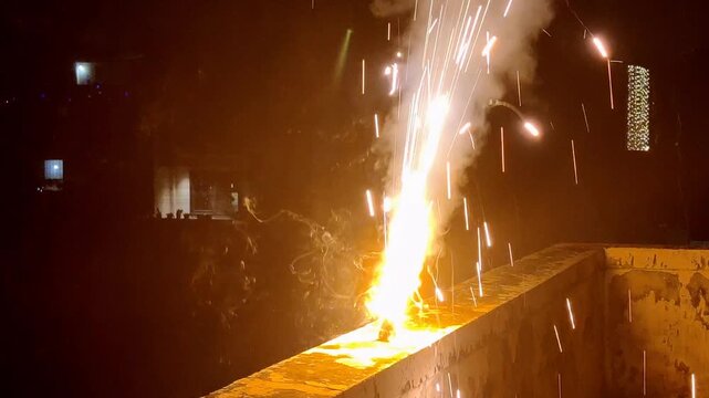 Footage of fireworks shot in the night sky as background. Close-up shot of fire crackers during festival of Diwali in India
