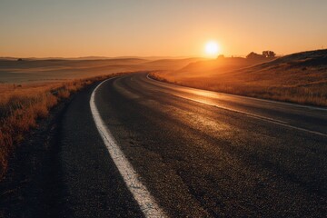 Fototapeta premium Sunrise light on a tranquil country road with expansive farmland