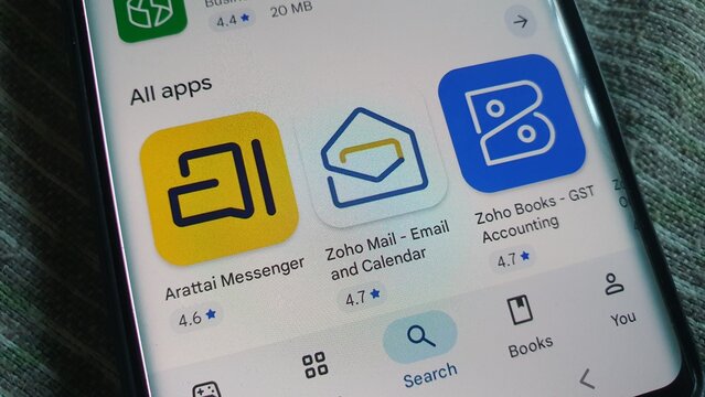 New Delhi, India - November 17 2025: Zoho Apps: Arattai Messenger, Zoho Mail, and Zoho Books on Phone