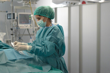 Surgeon woman preparing for medical surgery in operating room