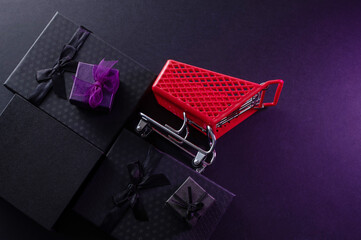Festive background composition of elegant black gift boxes with black satin ribbons and bows, symbolizing the Black Friday sale.