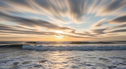 A breathtaking view of the ocean at sunset with vibrant clouds and gentle waves crashing onto the shore, creating a peaceful and scenic seaside landscape