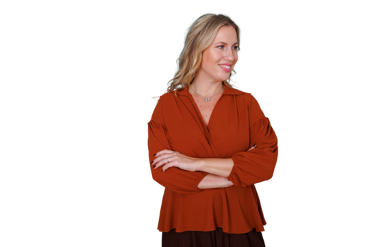 Mature blonde woman smiling and looking sideways, standing with arms crossed, portraying confidence, professionalism, and success. Transparent background