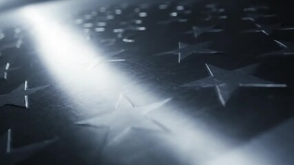 A solemn tribute on Veterans Day, with a beam of light illuminating embossed stars on a memorial, symbolizing honor and sacrifice for American freedom