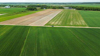 Car driving through green fields