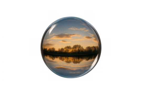 Glass sphere reflecting vibrant sunset landscape with trees and water, crystal ball showing an inverted natural horizon