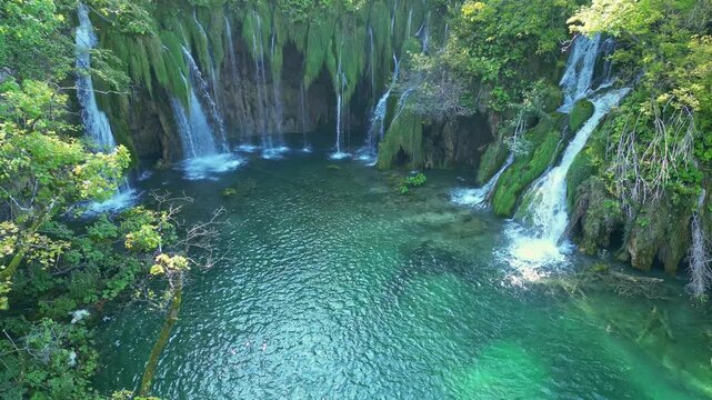 Beauty nature with waterfall. Panoramic aerial view of waterfalls. Beauty green nature. Plitvice lakes and Waterfall. Beauty waterfall landscape in Croatia. Crystal-clear water in Plitvice.