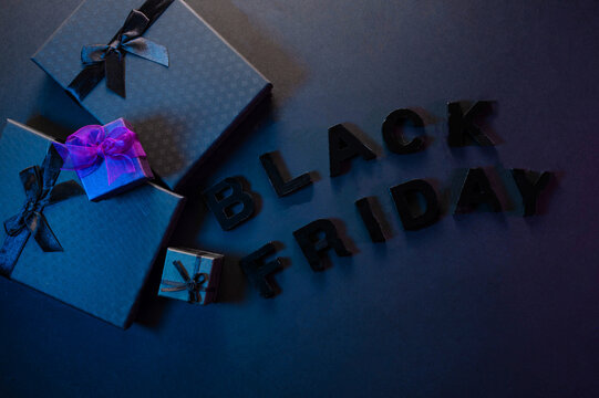 Festive background composition of elegant black gift boxes with black satin ribbons and bows, symbolizing the Black Friday sale. - Powered by Adobe