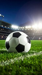 Fototapeta premium Soccer ball on green grass with stadium lights in background for match day atmosphere and sporting events.