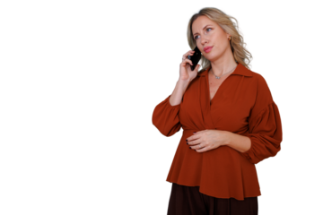 Blonde woman listening attentively and looking serious on a mobile phone call. She is communicating for business purposes