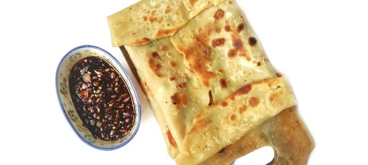 Martabak Telor with Soy Sauce Served On a Plate. Traditional Indonesian Street Food. Food Photography Presentation. Isolated on White Background