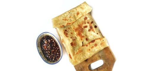 Martabak Telor with Soy Sauce Served On a Plate. Traditional Indonesian Street Food. Food Photography Presentation. Isolated on White Background