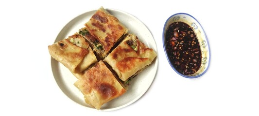 Martabak Telor with Soy Sauce Served On a Plate. Traditional Indonesian Street Food. Food Photography Presentation. Isolated on White Background