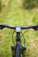 Naklejka premium Biker perspective on wooded path outdoors