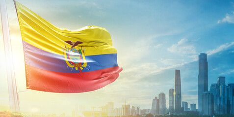 Ecuador flag wavering in beautiful clouds with building skyline. The flag with drone shot in...