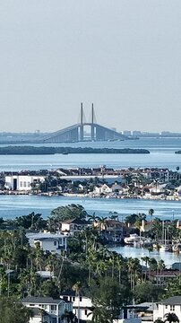 Aerial view of the Sunshine Skyway Bridge soaring over Tampa Bay, connecting land and sea in a symphony of engineering and natural beauty, St. Pete Beach, Florida, United States.