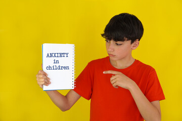 anxiety in children. children's mental health. child pointing to words in a notebook