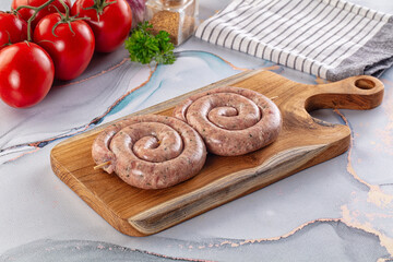 Raw meat pork and beef swirl sausages