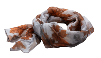 White and brown scarf with autumn leaf pattern, crumpled on a black background