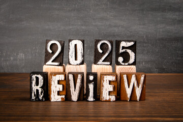 2025 Review Wooden Block Typography on Rustic Background