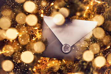 Christmas Envelope Gift Certificate Card among Christmas Tree Branches. Christmas Surprise Sale Greeting Card with Glitter Lights.