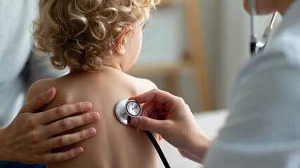 Doctor examining a child's back with a stethoscope during a medical check-up, demonstrating pediatric medical care.