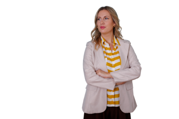 Focused businesswoman standing with crossed arms, looking sideways, projecting confidence and a professional attitude