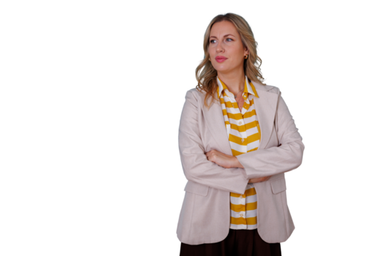 Focused businesswoman standing with crossed arms, looking sideways, projecting confidence and a professional attitude