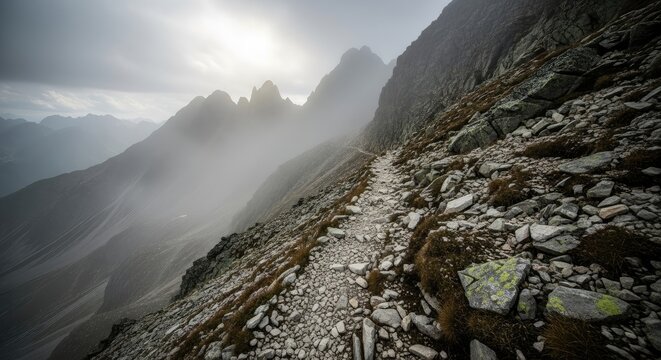 Rocky mountain path disappearing into the mist on a cloudy day view - Powered by Adobe