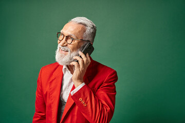 Senior man in stylish winter attire smiling while talking on the phone