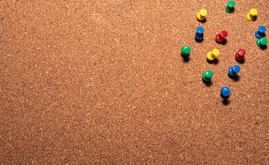 cork board with colored pins on it