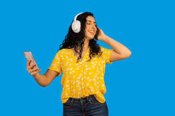 Happy woman enjoying music listening headphones smartphone