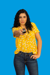 Woman holding remote control changing television channel