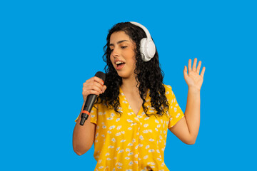 Woman singing with microphone, enjoying music and karaoke