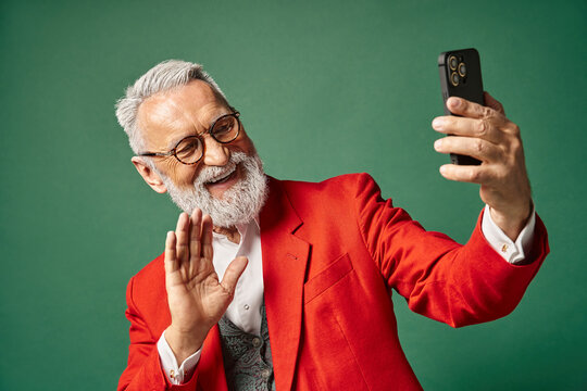 Senior man dressed in style enjoys winter moments while taking a joyful selfie