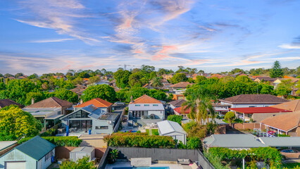 Fototapeta premium Aerial Panorama Drone View of a inner western Sydney Suburb of Ashbury Urban Sprawl and the terracotta roof tops streets and trees of Suburban Sydney NSW Australia