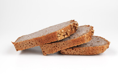 Pieces of sliced buckwheat bread on white background.