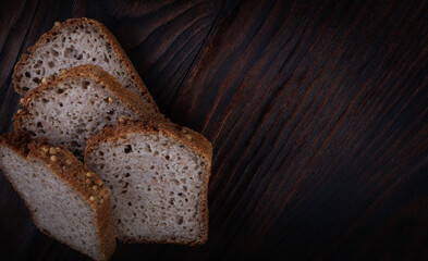 Sliced buckwheat bread on dark wooden background.