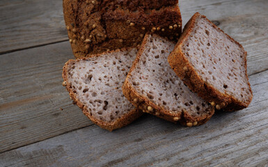 Sliced buckwheat bread on a light wooden background. Buckwheat bread with coriander.