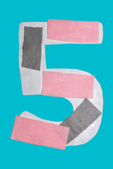 the number 5 symbol , with pink and gray felt strips, on a blue background