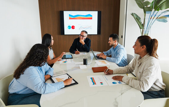 Multiracial colleagues working inside business office with glass walls - Entrepreneurs people sharing ideas at teamwork meeting - Brainstorming concept - Main focus on center man face