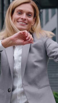 Happy crazy funny adult Caucasian business woman dancing jumping in city businesswoman having fun fooling around in downtown celebrating job success female rejoice victory celebrate joyful jump dance